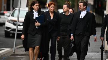 Pauline Hanson, second on left, arrives at the Federal Court of Australia in Sydney. Picture AAP