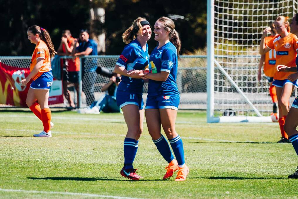 Neve Farquhar and Laura Dickinson celebrate a goal against Riverside during pre-season. Picture by Kaleb Clark