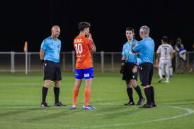 Players chat with officials during the break in play while Will Fleming was treated. Pictures by Floyd Jones