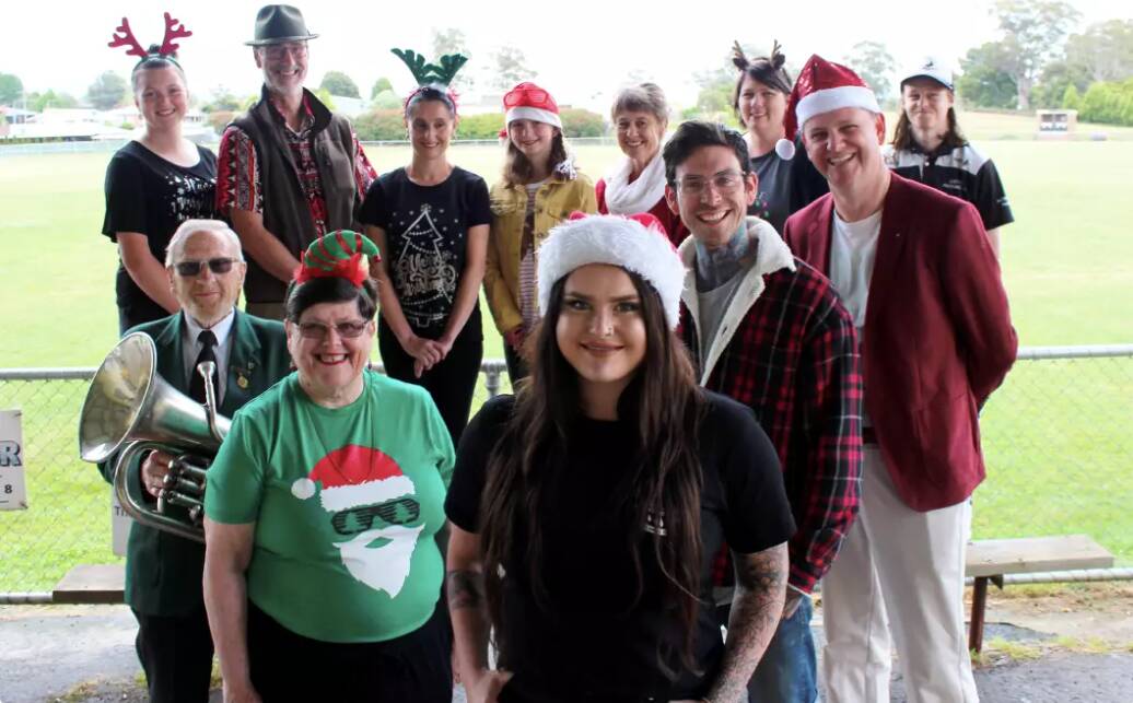 Carol singers, organisers and community group members with co-organiser Andrew Goelst, performers Matt Garwood and Michelle Rainbow, producer Rose Burden and euphonist Neville Gray. Picture: Hamish Geale. 