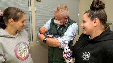 Jeremy Rockliff cradles four-day-old baby Rydar with Kayla Bowerman and Libby Kerkham.
