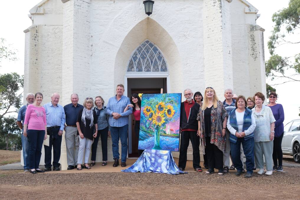 Artist Eleonora Pulcini (centre left) is donating some of the proceeds from her painting to the Windermere Church. Picture by Declan Durrant