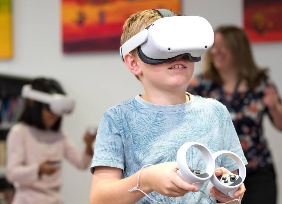 Flynn Grant age 10 tries out a VR headset at the Launceston Library. Picture by Philip Biggs