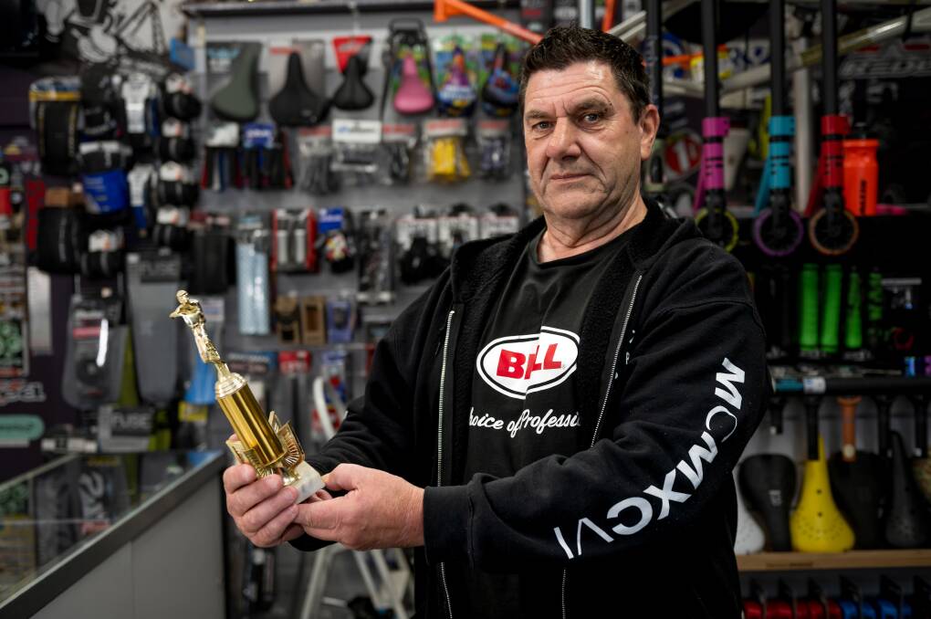 Patrick O'Callaghan of Pato BMX Plus in Elizabeth Street, Launceston, with the first trophy he won in the early '80s. Picture by Philip Biggs