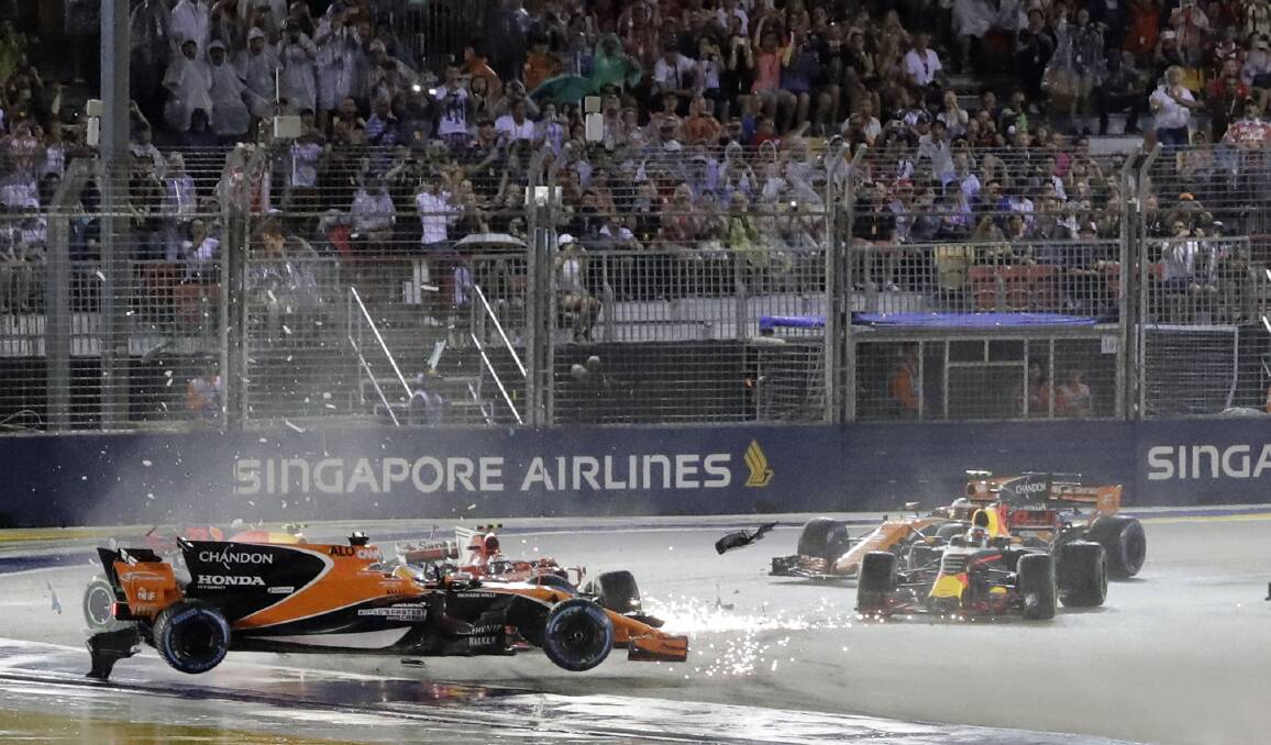 FAILURE TO FIRE: McLaren driver Fernando Alonso, left, after his collision with Kimi Raikkonen at the Singapore GP. Both Alonso and McLaren bosses have been highly critical of their Honda engines. Picture: AP Photo/Wong Maye-E