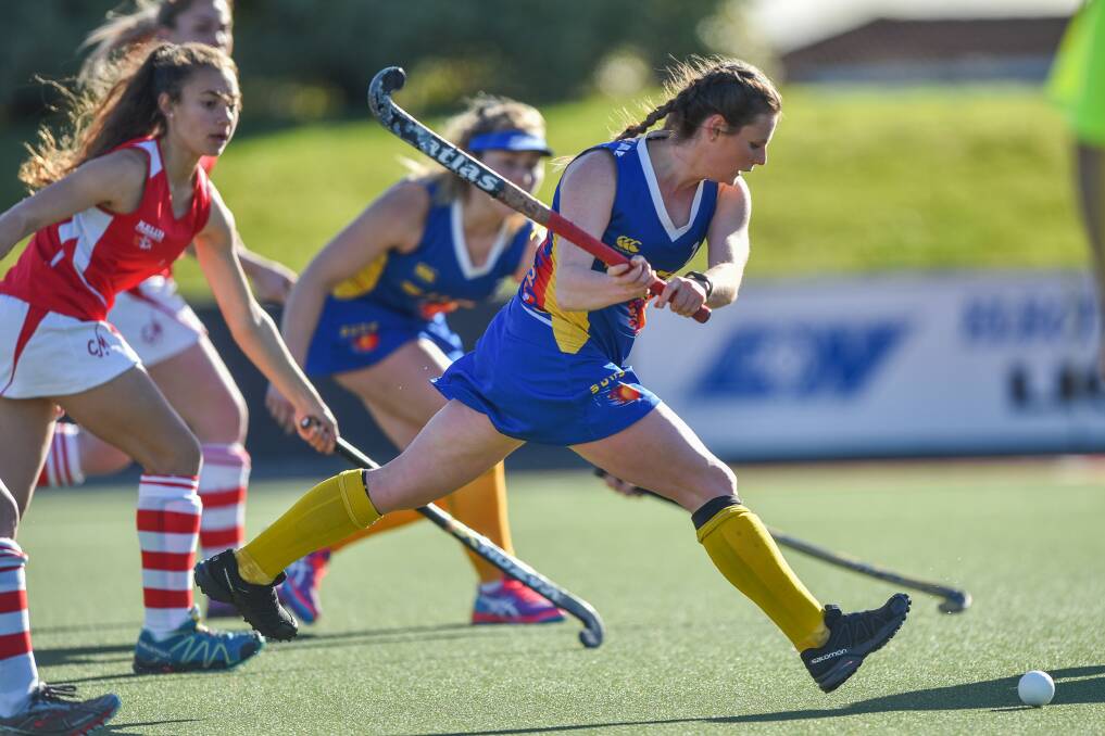 GIVING CHASE: South Launceston Suns' Kira Budgeon storms down the field pursued by City Marians players. The Suns took the win 4-nil. Picture: Scott Gelston