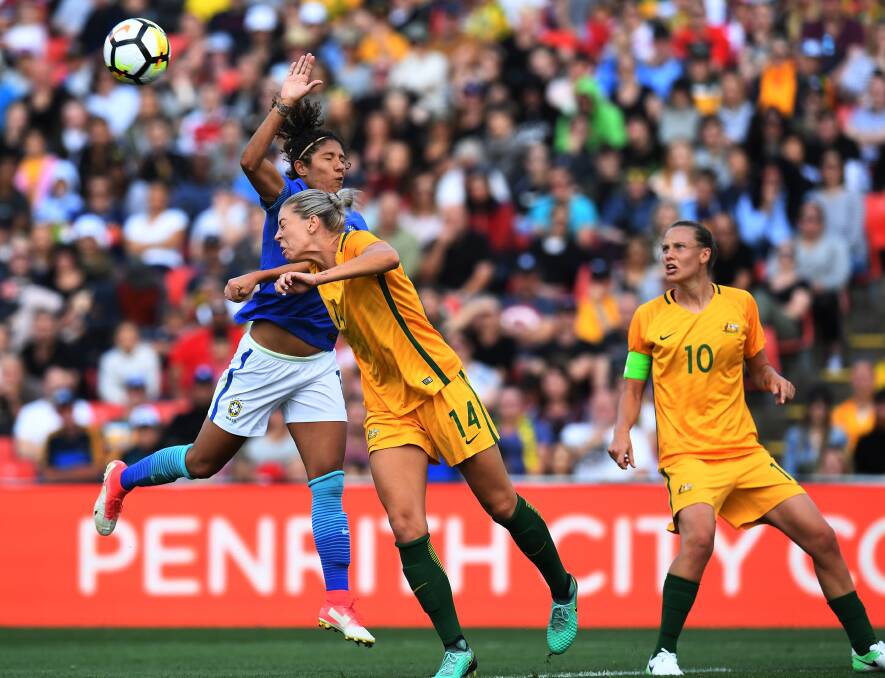WAY AHEAD: Matilda Alanna Kennedy and Brazil's Cristiane Rozeira de Souza Silva contest the ball. The Australian victories have given the sport a huge boost in popularity. Picture: AAP Image/Dean Lewins