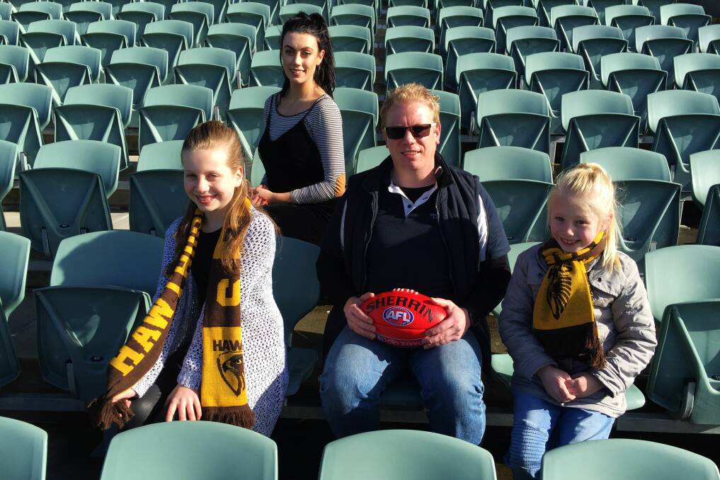 FOOTY: UTAS researcher Anthony James with footy fans Hollie James, Samantha James-Radford and Lilly James. PICTURE: Scott Gelston.