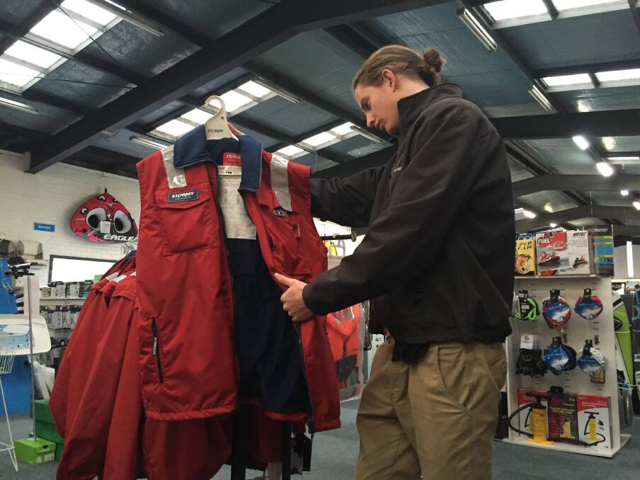 SAFETY FIRST: Laurence Farr from CH Smith Marine in Launceston checking over a Stormy PFD vest. 