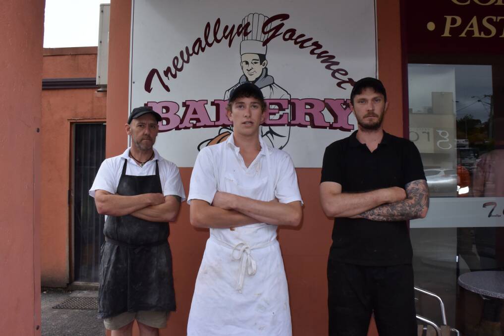 Trevallyn Bakery owner Tony Mitchell with workers Alex Duncan and Josh Humphries who were held up at gunpoint on Wednesday. 