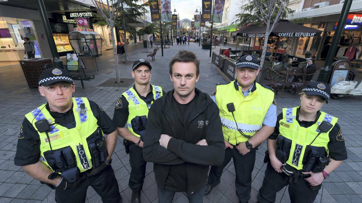 Launceston Retail Watch founder Luke Dawson (centre) with Tasmania Police officers in 2015, pushing for bans on shoplifters.