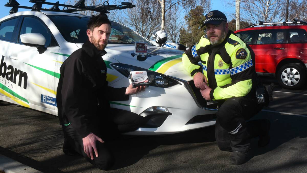 ROAD SAFETY: James Williams from Autobarn and Tasmania Police officer Darren Chynoweth. Picture: Neil Richardson