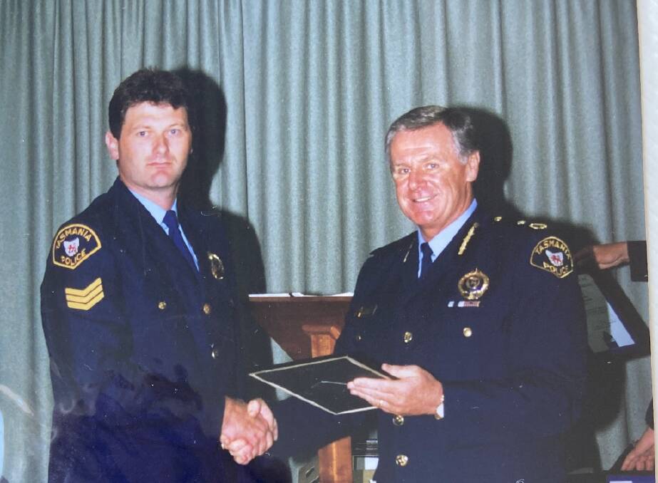 Receiving his National Medal for 15 years' of service.