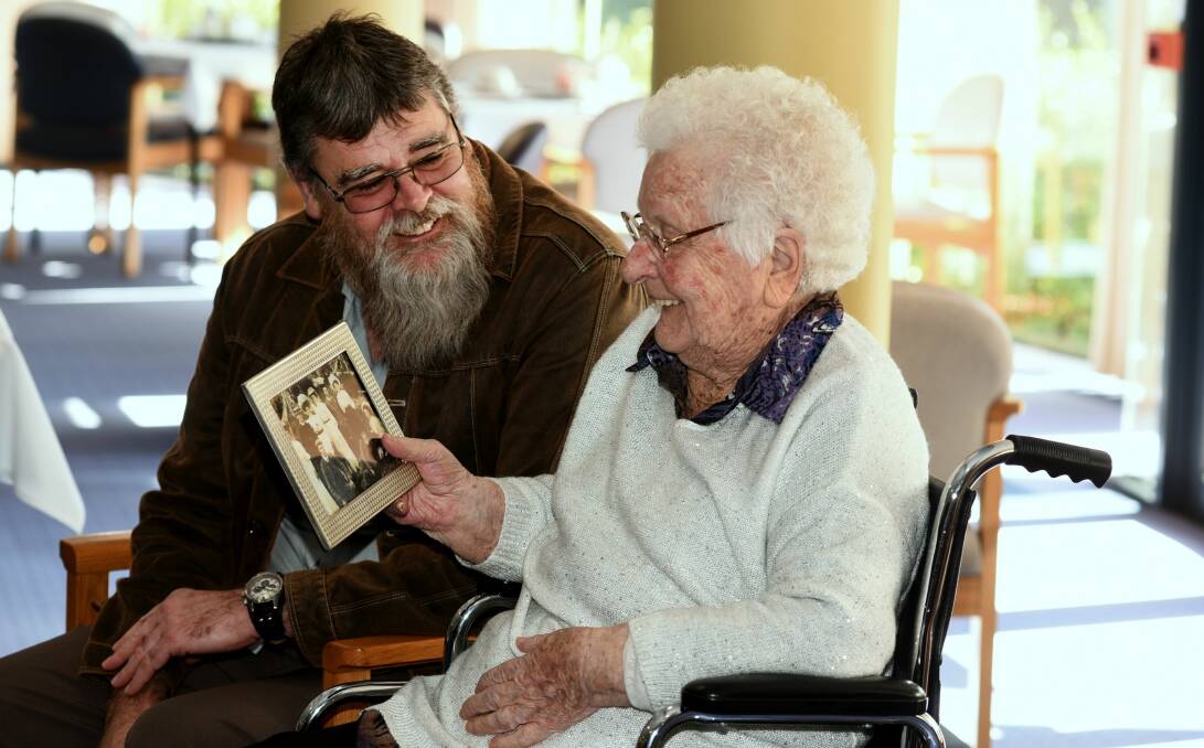 HISTORY: Michael Stanton gives Iris Roden a photo of her family taken in 1905 as a present for her 105th birthday. Picture: Neil Richardson.