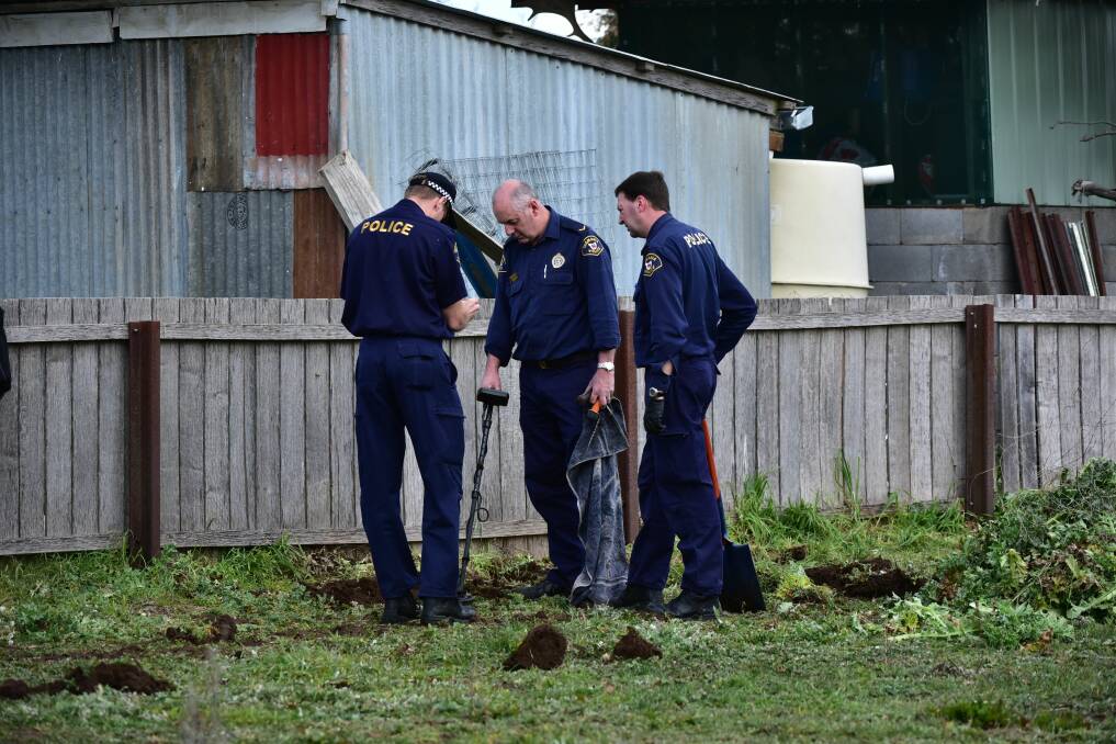COLD CASE: Forensic investigators search for bullet casings at the scene of the 2009 murder of Campbell Town resident Shane Barker. Picture: Neil Richardson