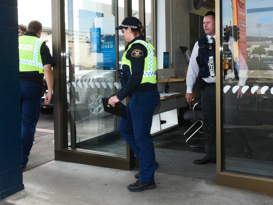 HOLD UP:Tasmania Police officers at the ANZ Bank in Mowbray where an alleged armed robber held a customer at knifepoint. Picture: Neil Richardson