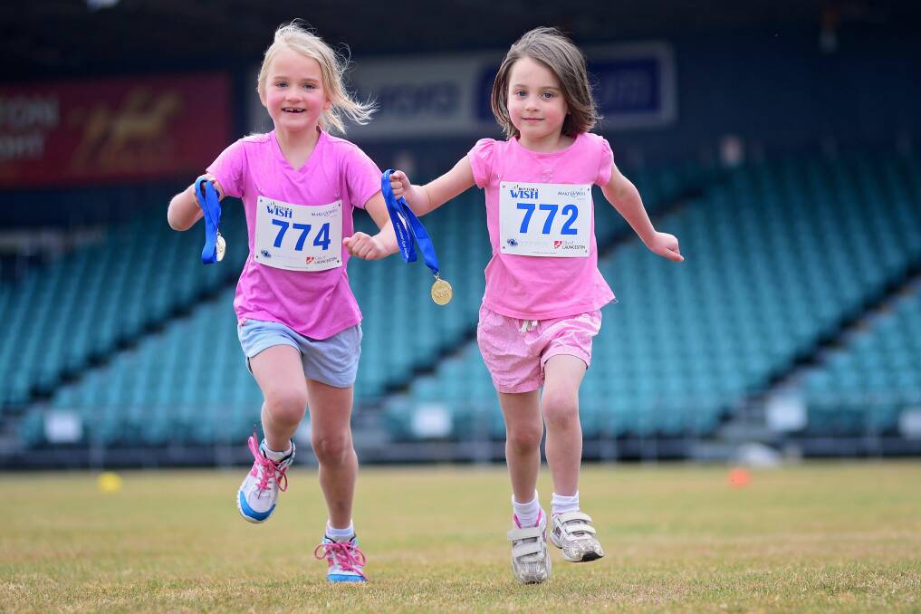 Millie and Charlotte Hoffner completed the children's race at the Run For A Wish event in Launceston.