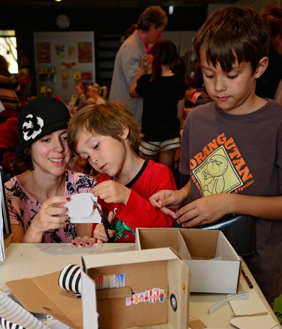 CREATING: Joanna Satel with her two sons Harry, 5, and Max, 8, create miniature houses as part of the Launceston LINC’s school holiday program. Picture: Phillip Biggs