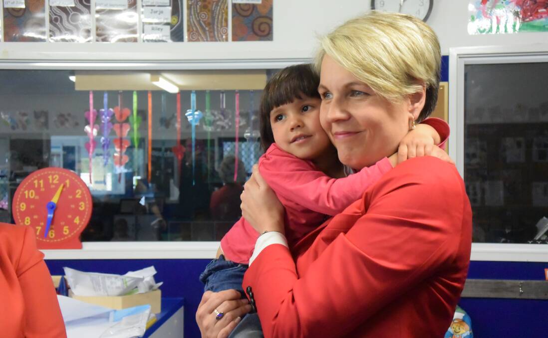 CHILDCARE: Deputy Labor leader Tanya Plibersek holds Masoumeh Azizi, 3, while visiting Goodstart Early Learning in Launceston on her first full day of campaigning. 