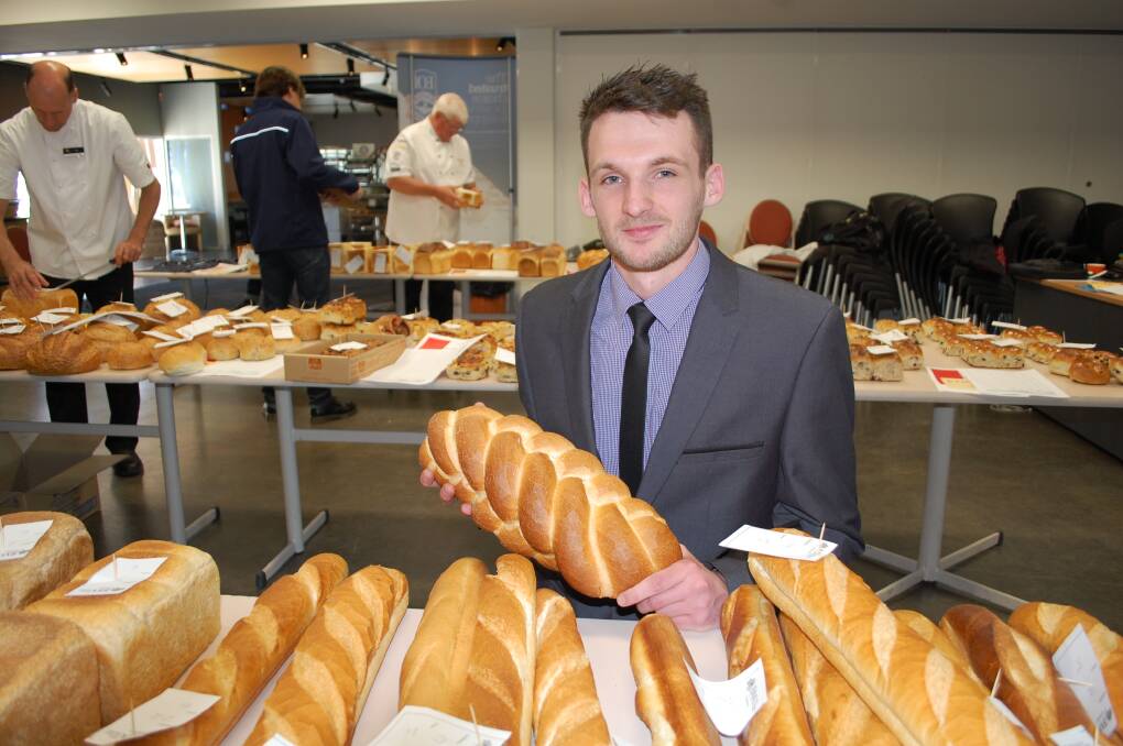 BAKING: Winner of the 2016 Tasmanian Apprentice Baker of the Year, Brad Comins, holding his five-strand plait loaf at the Baking Industry Awards at TasTAFE. Picture: Michelle Wisbey