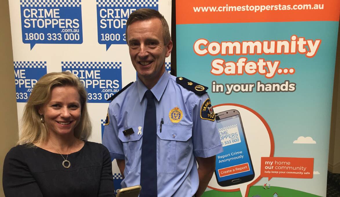 NEW TECHNOLOGY: Crime Stoppers chairwoman Amanda Castray and Tasmania Police Commissioner Darren Hine launch a new online crime reporting system. 