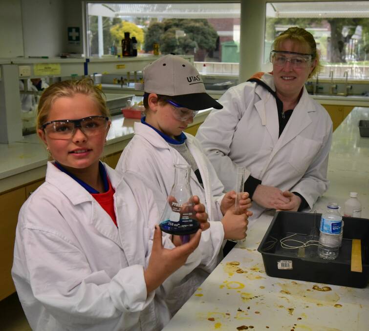 SCIENCE: University of Tasmania chemistry technical officer Cathy Tyson with grade 4 Ringarooma pupils Shanna Samec and Benjamin Cresswell. Picture: Paul Scambler
