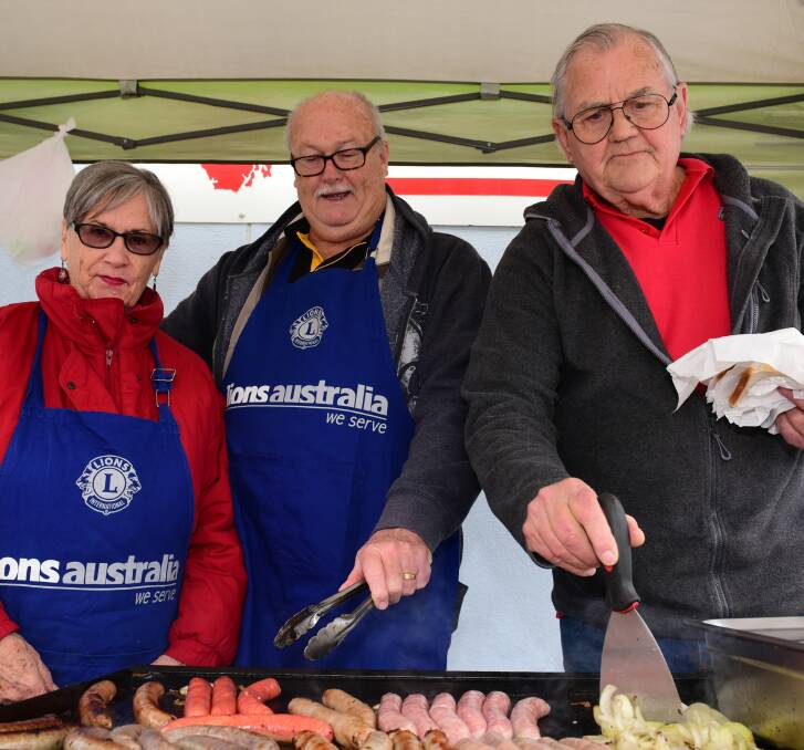 SNAGS: St Helens Lions Club members Colleen Nalder, Steve Low and Tony Bradley at The Examiner's community barbecue. Picture: Paul Scambler