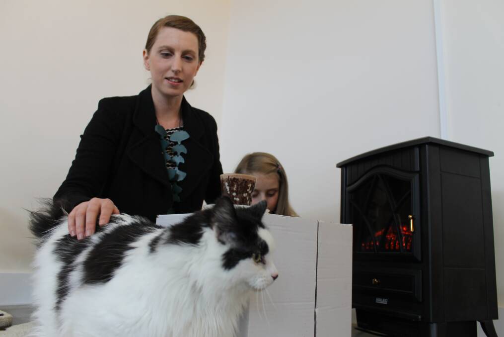 PREPARING: Hobart Cat Cafe co-owner Sarah Honeyman and her daughter Israel with Daisy, one of ten resident cafe cats.