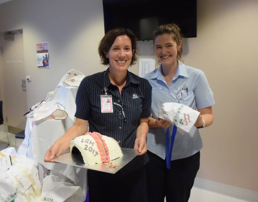 DEDICATION: Launceston General Hospital Queen Victoria Maternity Unit registered midwives Alison Campbell and Geraldine Beaubien with a bonnet cake, made by Mrs Campbell, and bonnets made in memory of convicts.