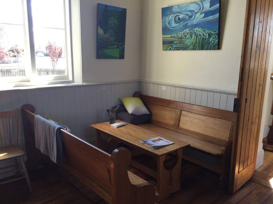 COSY CORNER: Pews from the old chapel are now used to seat customers enjoying food and drinks in a sun-drenched Ut Si. 