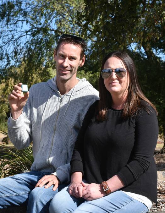 FRIENDSHIP: Scott Bailey, holding his medication container, and Hayley Milne, who both have young onset Parkinson's disease, at a Heritage Forest barbecue to raise awareness and funds on Saturday. Picture: Neil Richardson