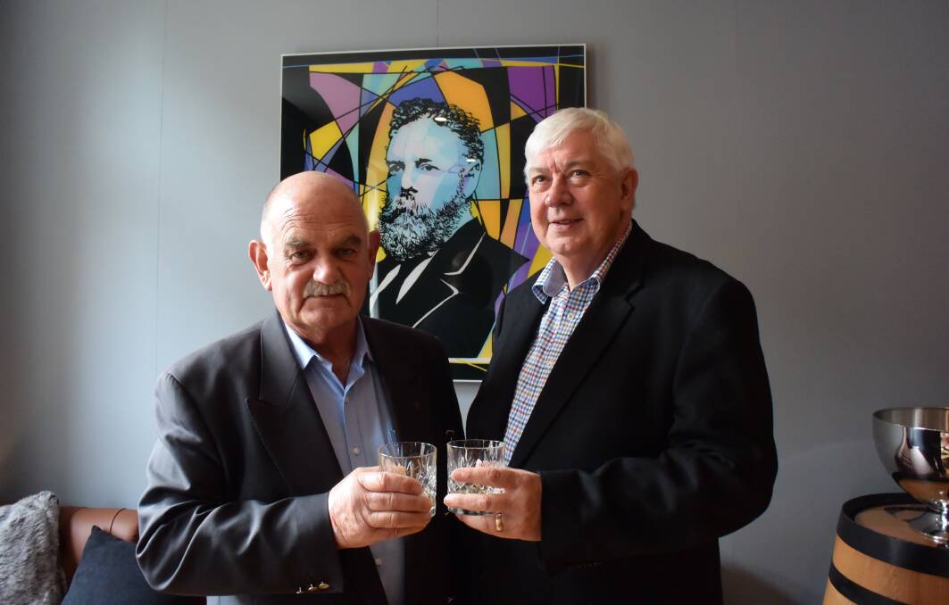 HISTORY: Russell Hogarth, former Northern Club secretary manager, and Don Jones, who was twice president, at the old club with a portrait of first president Henry Ritchie. 