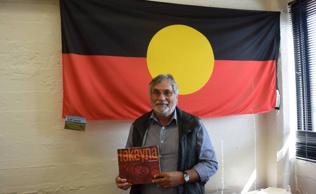 CAMPAIGN: Aboriginal Land Council of Tasmania chairman Clyde Mansell with the book, 'takayna - country, culture, spirit'. Picture: Tamara McDonald