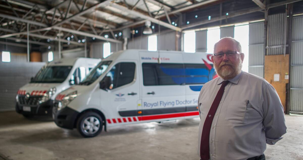 NEW PROJECTS: Royal Flying Doctor Service Tasmania chief executive John Kirwan, in a space the service will soon extend into at the base, alongside vehicles for the RFDS new patient transport program. Picture: Scott Gelston