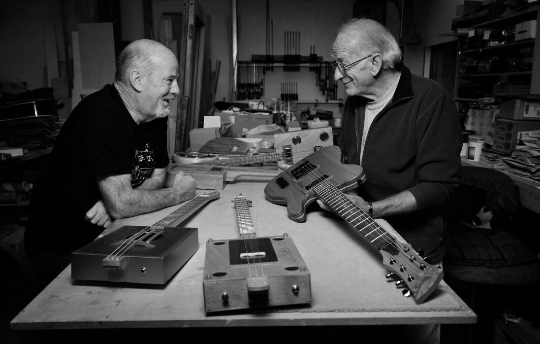 EXCHANGING TALES: Bruce Trappes and Stuart Phillips examine a StringWorx Custom Guitars guitar in Mr Phillips' shed. Pictures: Scott Gelston