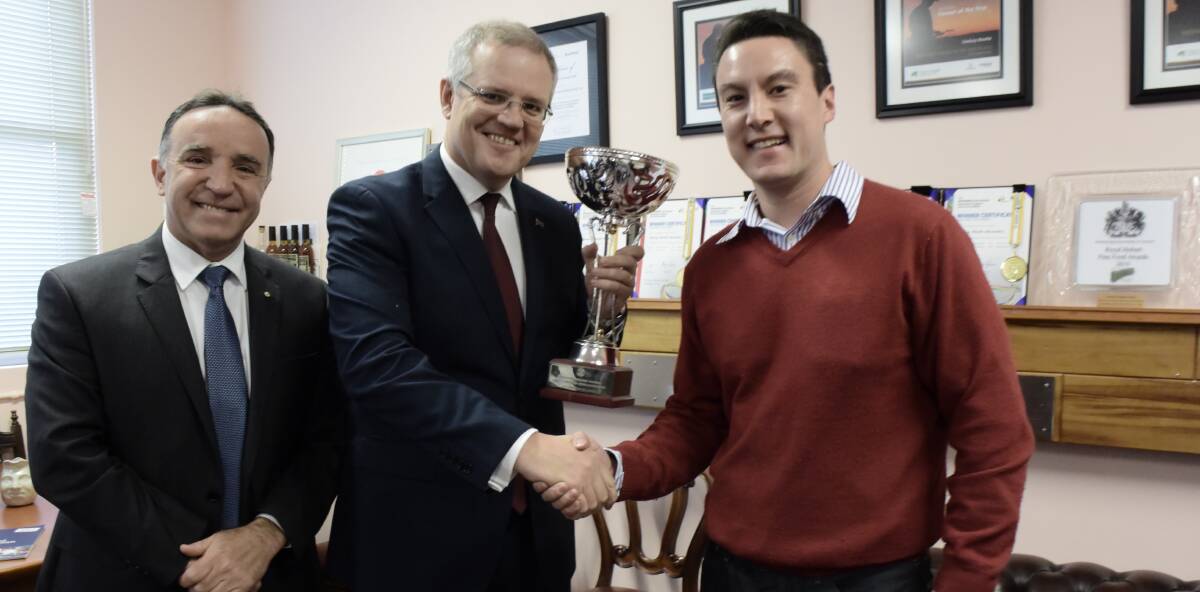 SUCCESS: Jeff Bourke receives the world's best honey trophy from Bass Liberal MHR Andrew Nikolic and Treasurer Scott Morrison. 