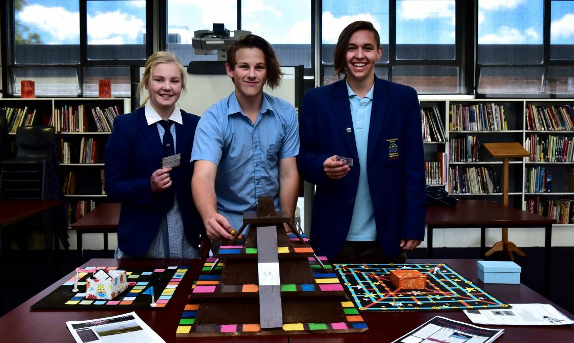 INNOVATION: Sarah Larcombe, William Bryan and Brodie Eyles have designed a board game based on their science lessons. 