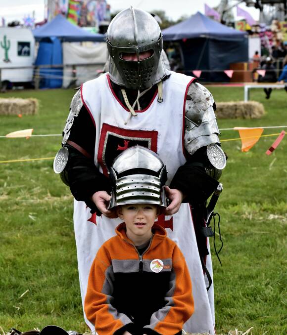 BATTLE READY: Rebecca Wealands fits Abel Denardo with a helmet during a sword fighting display at the Longford Show. Picture: Neil Richardson 