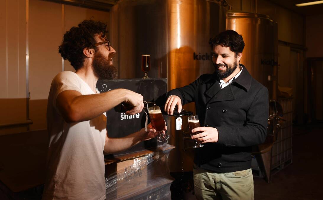 FLOWING: Andrew Swift, of Kick Snare Brewing, and Bill Armstrong, of Not For Horses, share a freshly brewed beer. Picture: Scott Gelston