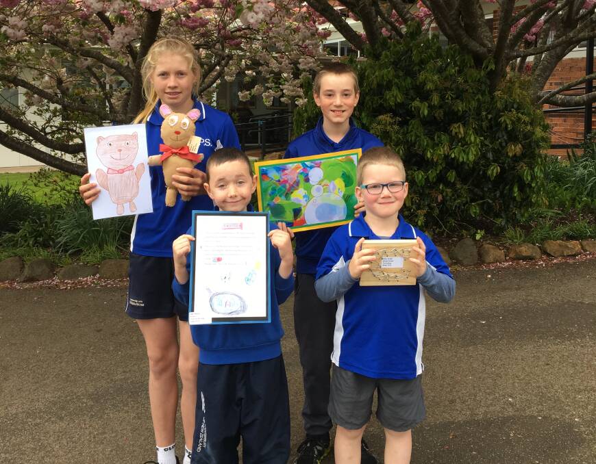 CREATIVITY: Primary school pupils Amelia Ranson, 12, Kobi Moore,7,  Max Rossiter, 11 and Coby Brown, 5, display their art work to be presented at the show. 