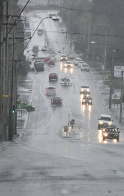 POURING DOWN: On wet, slippery roads, drivers should drive to the conditions. Photo: Neil Richardson