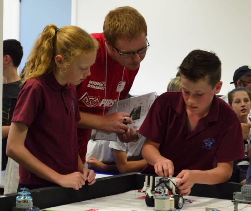CREATE: Star of the Sea College students Monique Hawkins and Alex Latham have their work looked over during Tasmania’s First Lego League competition. Picture: supplied