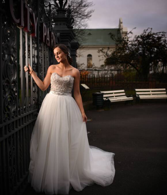 WEDDING READY: Launceston's Kate Smith in a Cosmobella gown from Timeless Elegance, during a photo shoot at City Park. Dresses like this will be on show at Weddings at the Albert on Sunday. Picture: Scott Gelston