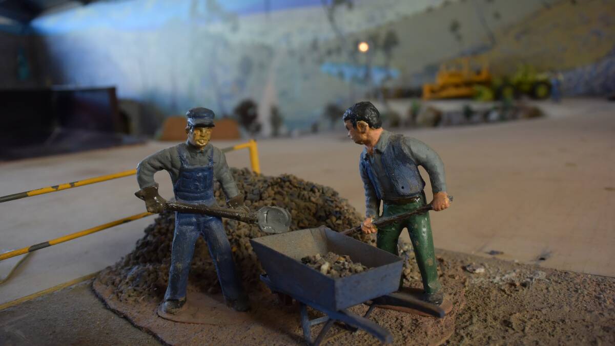 Figures of workmen working at the quarry site.