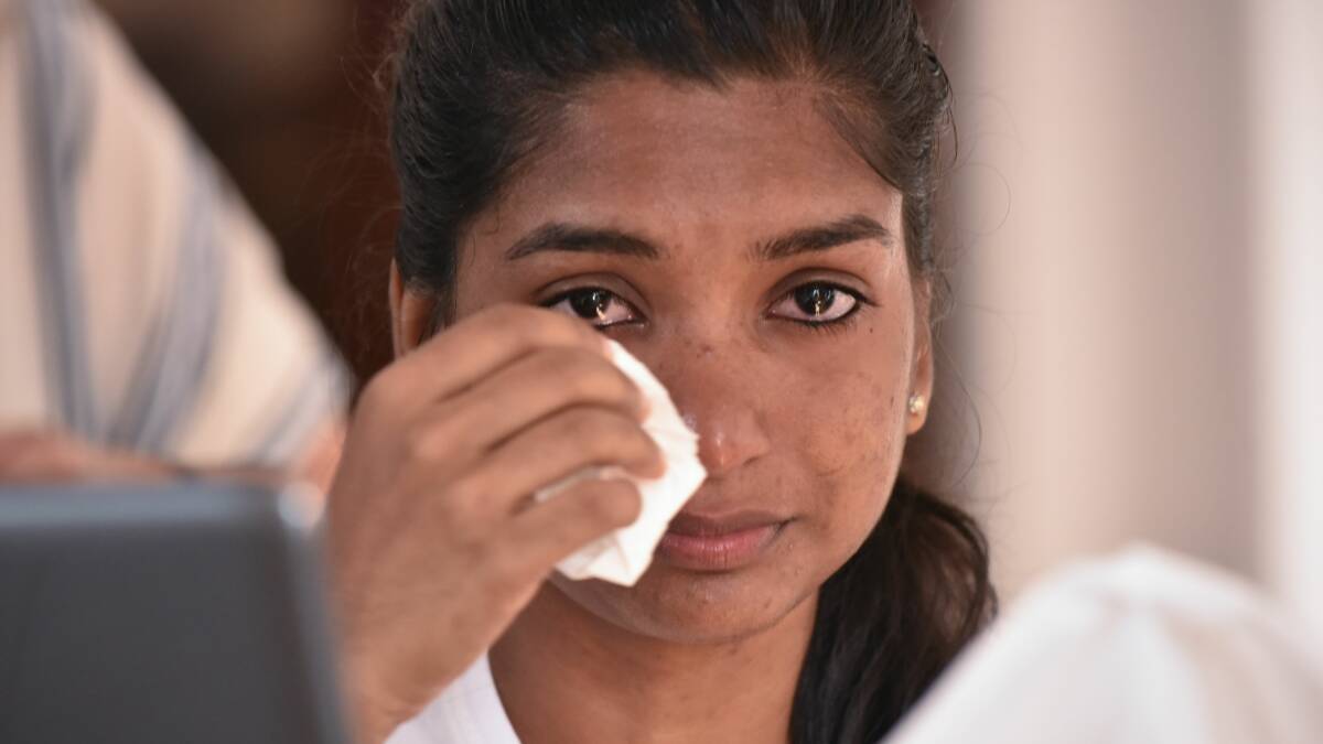 SCARED: Sri Lankan student Kaushalya Ilangkovan was doused in Coca-Cola as her terrified family looked on at a bus stop on Tuesday night. Picture: Neil Richardson