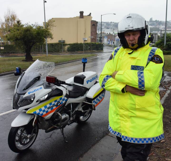 SAFETY: Tasmania Police Constable Anthony Purcell monitors road users in the wet weather along the East Tamar Highway, Launceston. Six people died in a week on wet roads last week. Picture: CHRIS CLARKE
