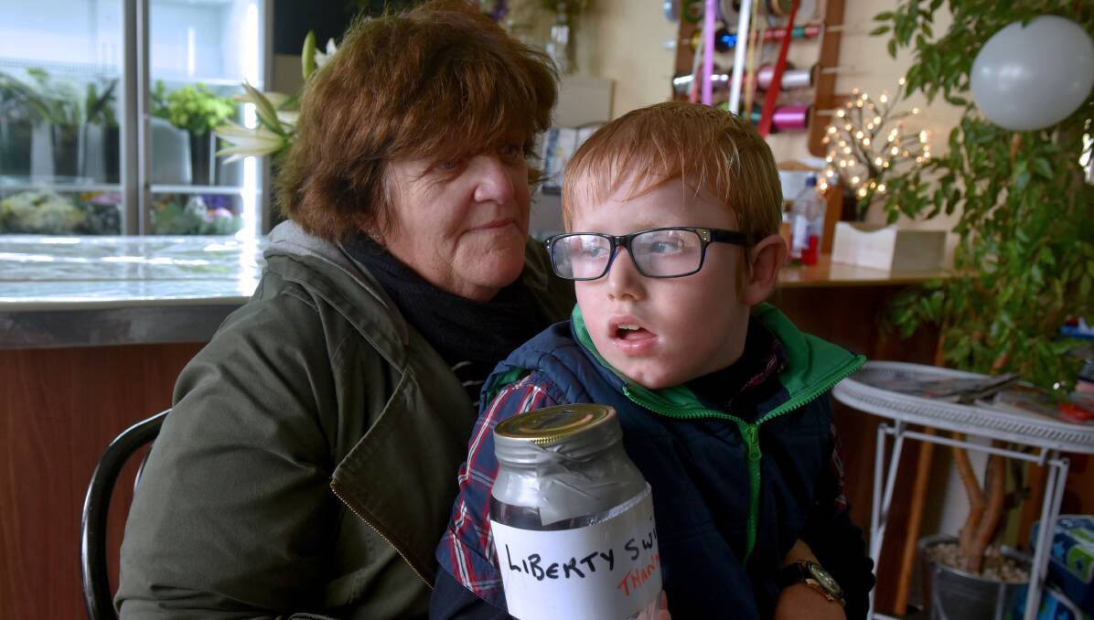 DEVASTATED: Karen Bell and her son Allan are still reeling after a charity jar with hundreds of dollars in it was stolen. Picture: Neil Richardson