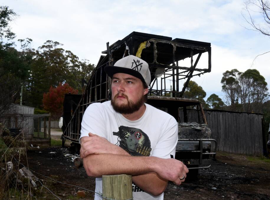 BURNT OUT: WSM Freestyle Entertainment president Jay Woolley stands in front of the club's torched truck and trailer in his Nunamara backyard. Picture: NEIL RICHARDSON