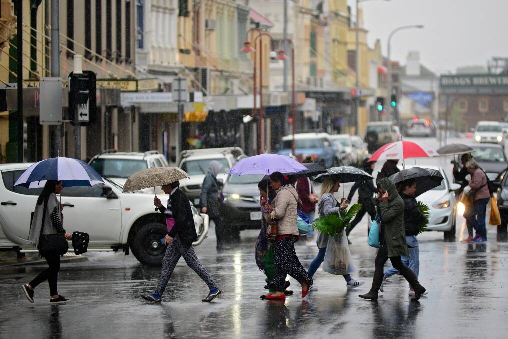 WET: Launcestonians reached for their umbrellas on Thursday, after wild weather was predicted. No significant damage was caused despite the conditions. Picture: Phillip Biggs