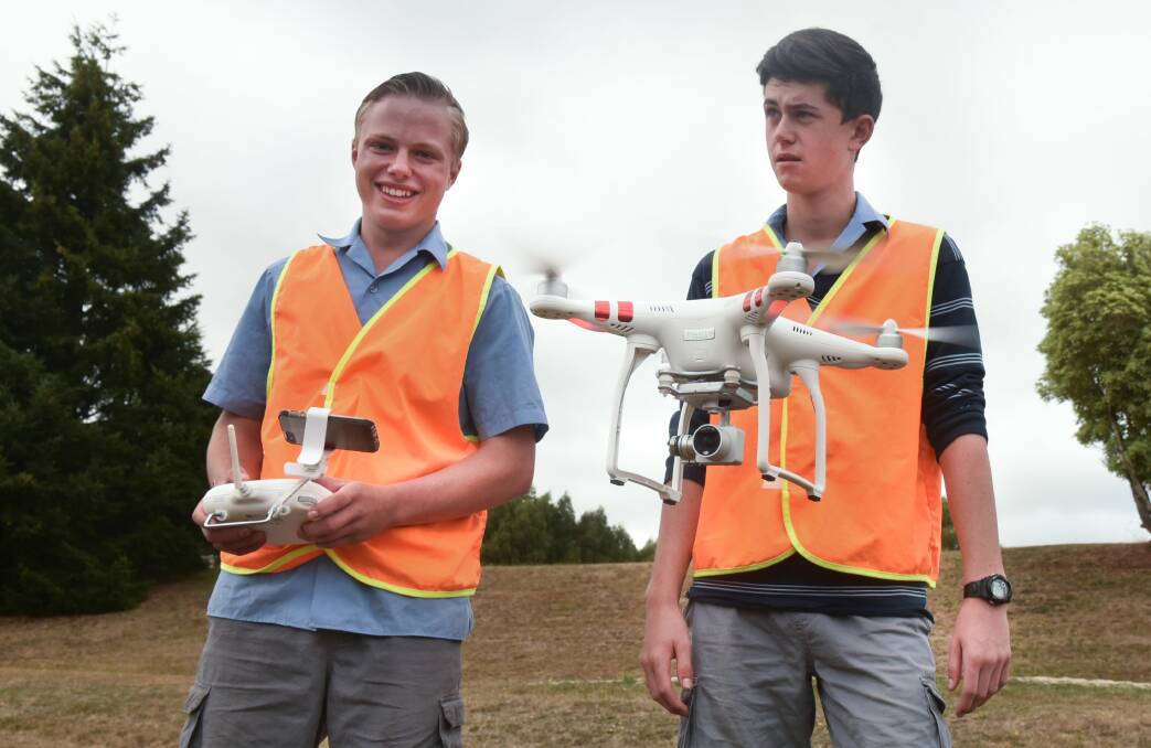 Deloraine High School students Jayden Lee and Nathan Drake get the drone ready for the photo. Picture: Neil Richardson